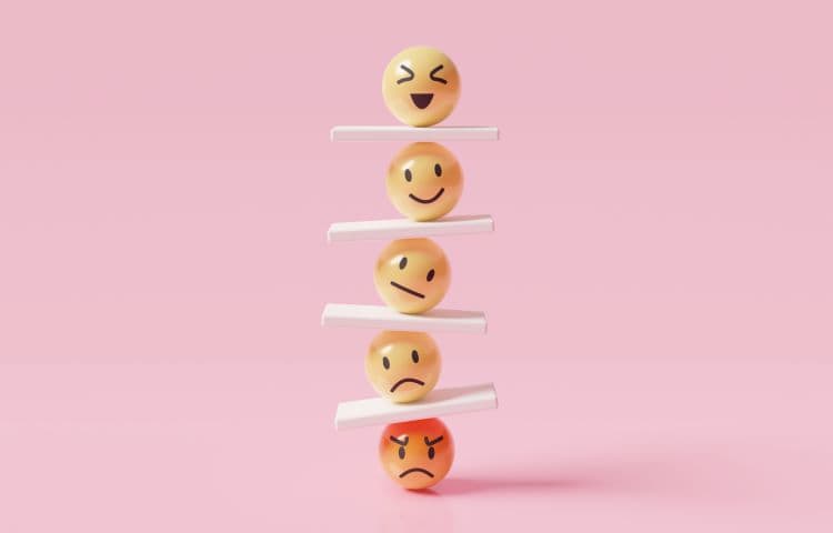 emoticons vertically arranged with seesaws to show emotional intelligence and control for career success and wellbeing for a customer success team